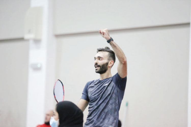 Raising my arm while holding a racket